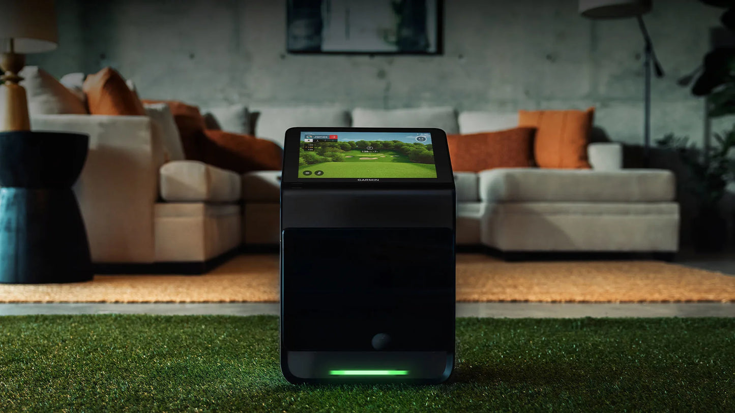 Garmin Approach R50 golf simulator with touchscreen display in modern living space.