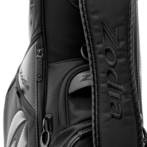 Close-up of Zodia Carbon Design Caddy Bag II showing durable carbon-look fabric and adjustable shoulder strap.