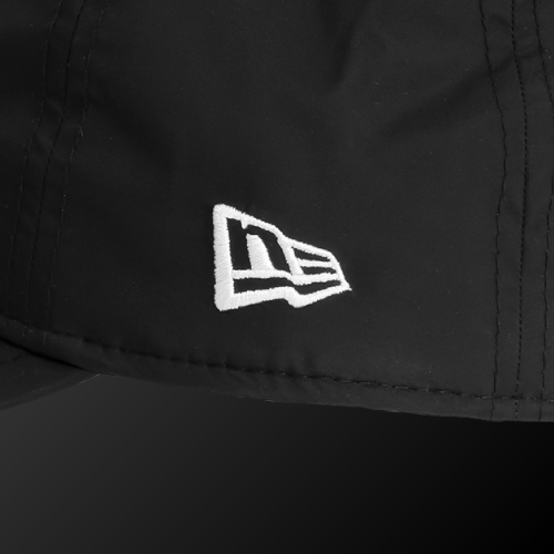 Close-up of Zodia Waterproof Rain Cap showing the logo on a black nylon material for high water resistance.