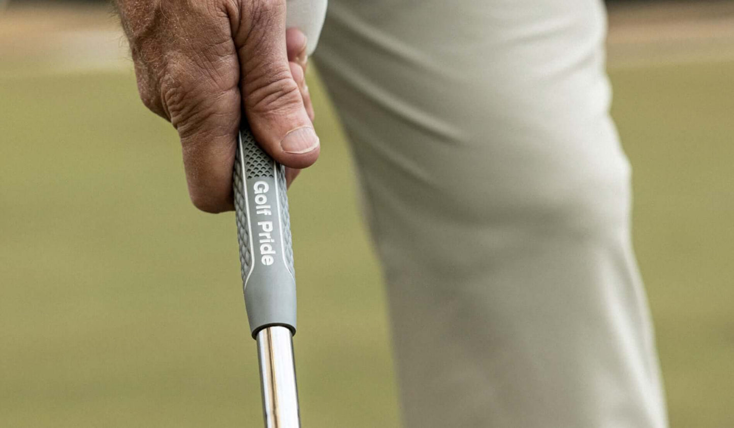 Close-up of a golfer's hand gripping the soft Golf Pride CPx grip, showcasing comfort and performance features.