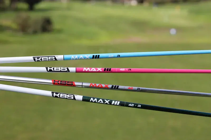 KBS MAX HL graphite wood shafts in various colors displayed on a golf course, designed for optimal swing performance.