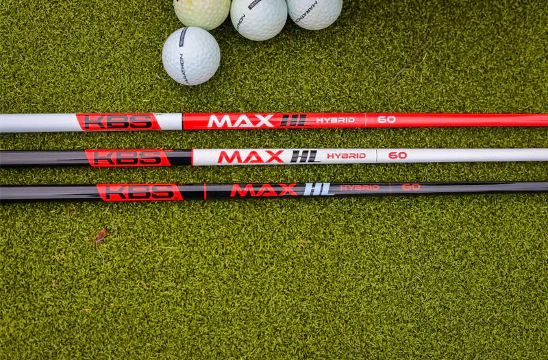 KBS MAX HL Hybrid Shafts displayed on green turf with golf balls, showcasing innovative graphite design for improved swing speed.