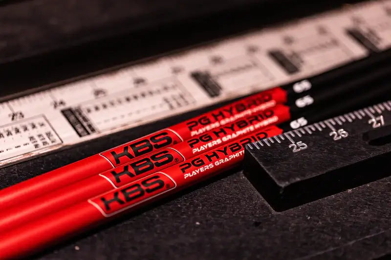 KBS PGH Players Graphite Hybrid Shafts displayed with a ruler for precise measurement and comparison.