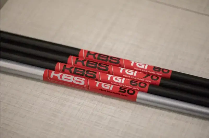 KBS TGI Tour Graphite Iron shafts featuring labels for TGI 50, TGI 60, and TGI 80 on a textured surface.