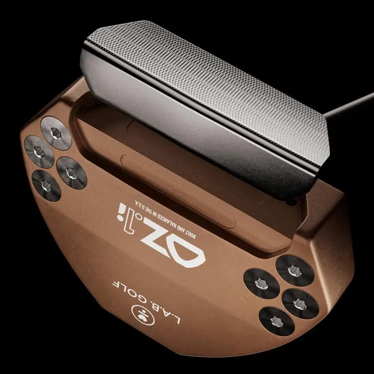 Top view of L.A.B. OZ.1i Stock putter in bronze with black grip, showcasing its design and construction.
