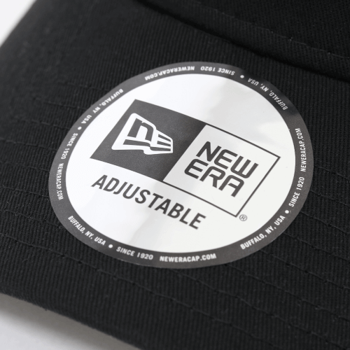 Close-up of New Era adjustable cap label showcasing logo and branding details.