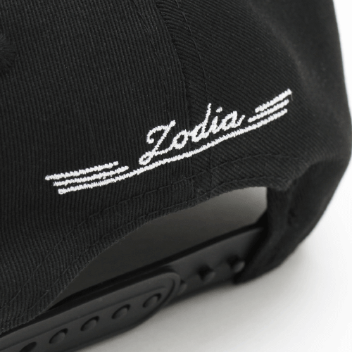 Black cap detail showing 'Zodia' embroidered logo on the back, emphasizing stylish design and adjustable fit.
