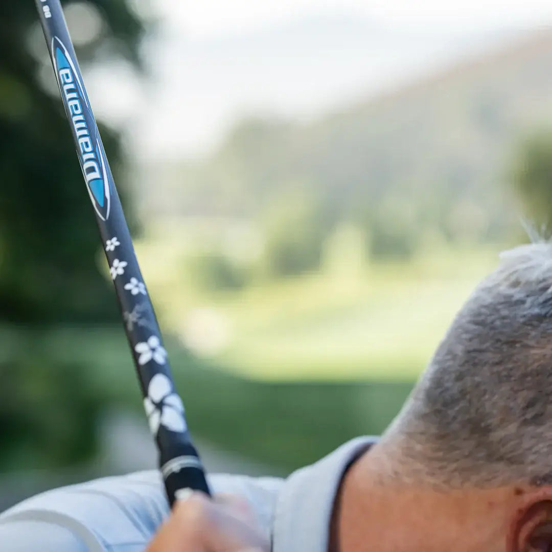 Mitsubishi Diamana BB Blueboard wood shaft with intricate design, showcased outdoors on a golf course.
