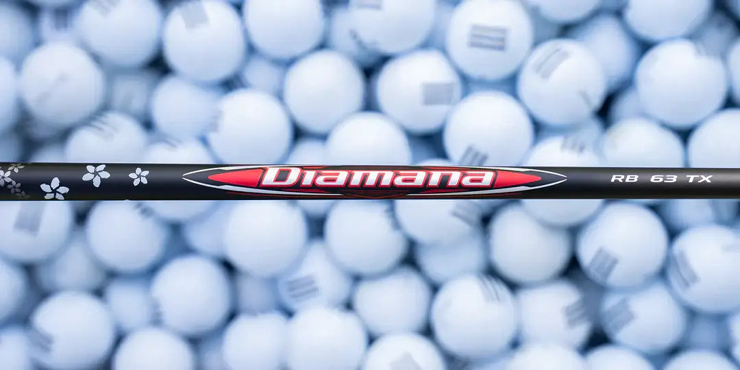 Mitsubishi Diamana RB Redboard wood shaft against a backdrop of white golf balls, designed for performance and customization.