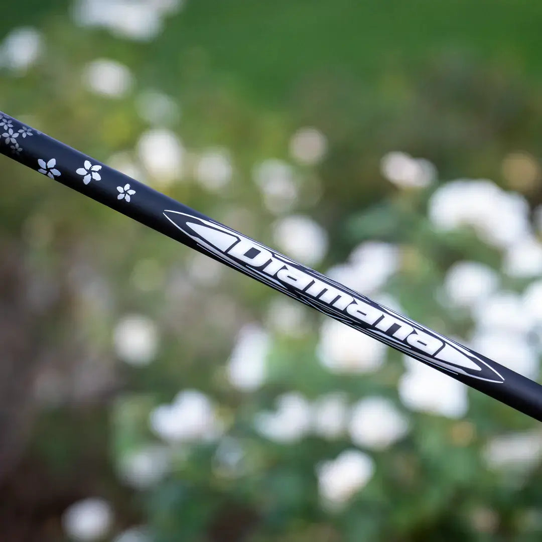 Mitsubishi Diamana WB wood shaft design featuring intricate floral details against a blurred background.