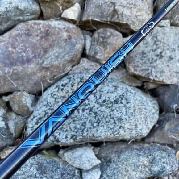 Close-up of Mitsubishi VANQUISH driver shaft showcasing its premium design against a stone background.