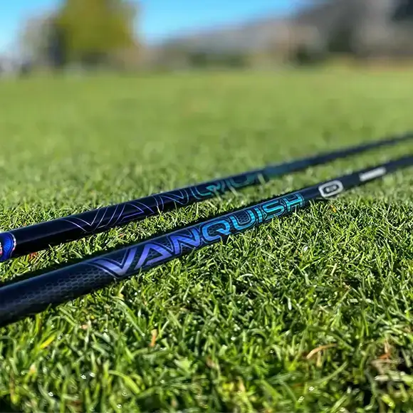Mitsubishi VANQUISH driver shafts displayed on grass, showcasing high-performance design for golfers.