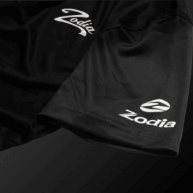 Zodia Splash Polo Shirt showcasing the silicone logo on a black sleeve, perfect for stylish summer wear.