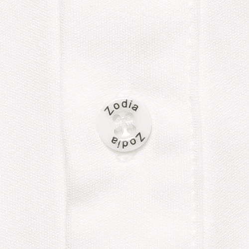 Close-up of Zodia Splash Polo Shirt button featuring the Zodia logo in white on a textured fabric background.