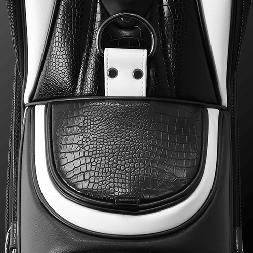 Close-up of Zodia Standard Caddie Bag with luxurious caiman pattern in black and white, highlighting stylish design and magnetic pocket.