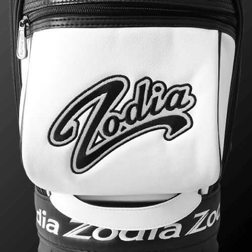 Zodia Standard Caddie Bag logo close-up in black and white leather design on a sleek background.
