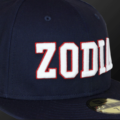 Navy Zodia × NEW ERA 59FIFTY Flat Visor Cap featuring bold white lettering on a classic design.