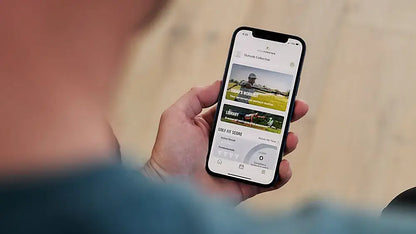 Person using GolfForever™ Swing Trainer+ app on a smartphone, showcasing video-based golf training programs.