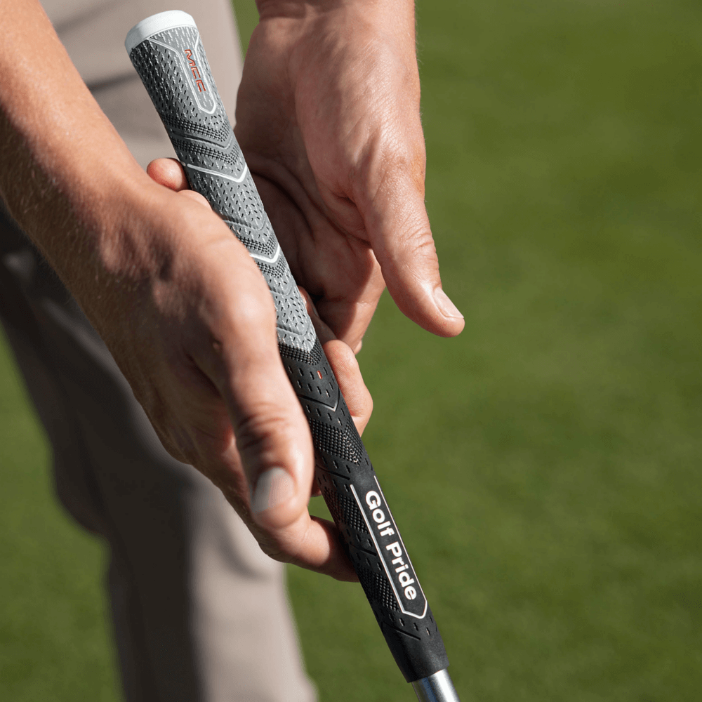 Golfer holding Golf Pride MCC Plus4 ALIGN MAX grip, showcasing its innovative design and raised ridge technology.