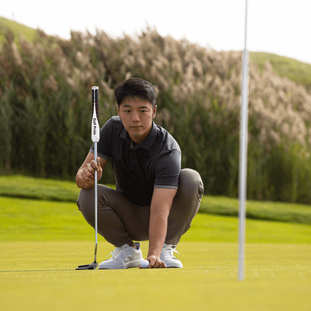 Golfer optimizing putting technique on the green with Golf Pride Reverse Taper putter grip.