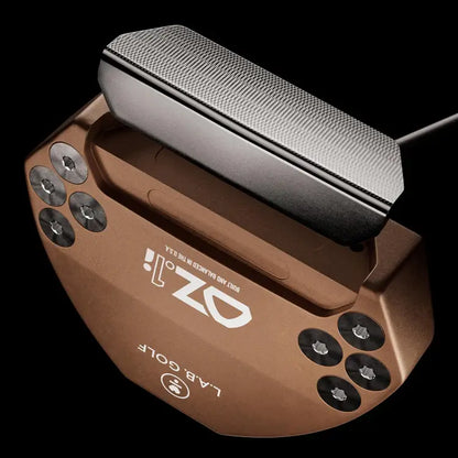 Top view of L.A.B. OZ.1i Stock putter in bronze with black grip, showcasing its design and construction.