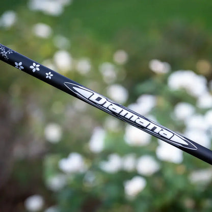 Mitsubishi Diamana WB wood shaft design featuring intricate floral details against a blurred background.