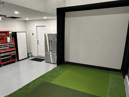 Golf Simulator Value Package setup featuring a hitting enclosure and a short-throw projector in a home studio.