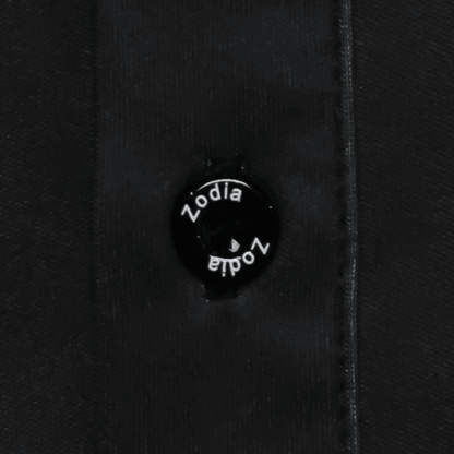 Close-up of the Zodia Splash Polo Shirt button showcasing the logo design.