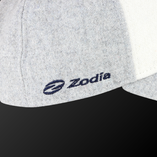 Close-up of Zodia × NEW ERA wool cap showcasing gray fabric and navy logo, perfect for autumn and winter outfits.