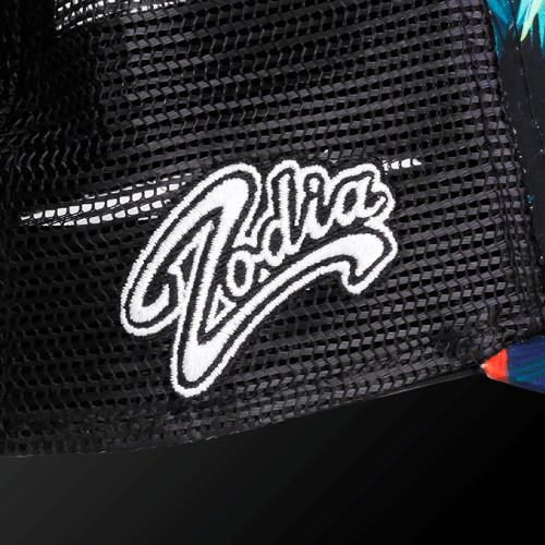 Close-up of Zodia logo on a black mesh cap with botanical pattern, highlighting summer resort style.