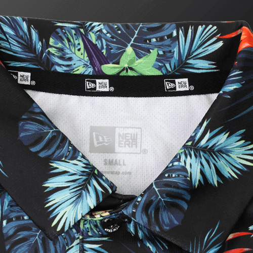 Close-up of the collar of a Zodia Botanical Polo Shirt featuring vibrant tropical patterns.