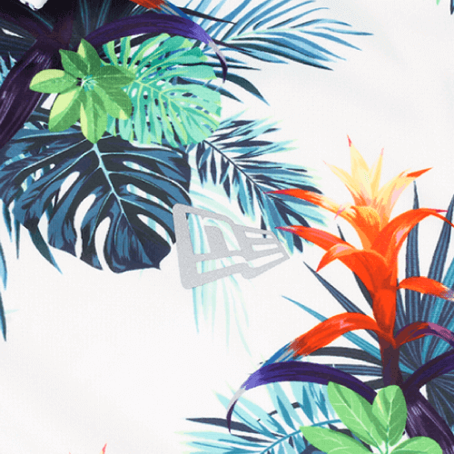 Close-up of Zodia Botanical Polo Shirt fabric showcasing vibrant botanical pattern with reflective logo.