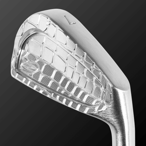 Close-up of Zodia Caiman IV CB golf club head showcasing polished S20C soft iron design and intricate face details.