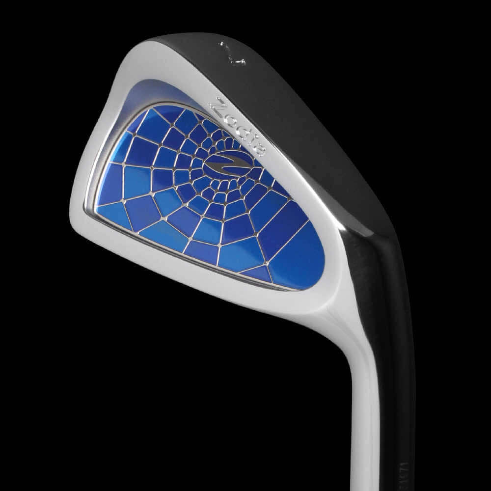 Zodia CAVITY BADGE golf club close-up showing blue badge design and forged soft iron construction.