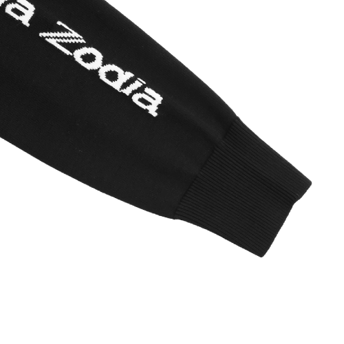 Close-up of the sleeve of a Zodia Crewneck Sweater featuring white logo detail on a black background.