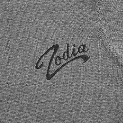 Close-up of Zodia logo on a gray crewneck sweater, showcasing its stylish and distinct embroidery.