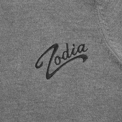 Close-up of Zodia logo on a gray crewneck sweater, showcasing its stylish and distinct embroidery.