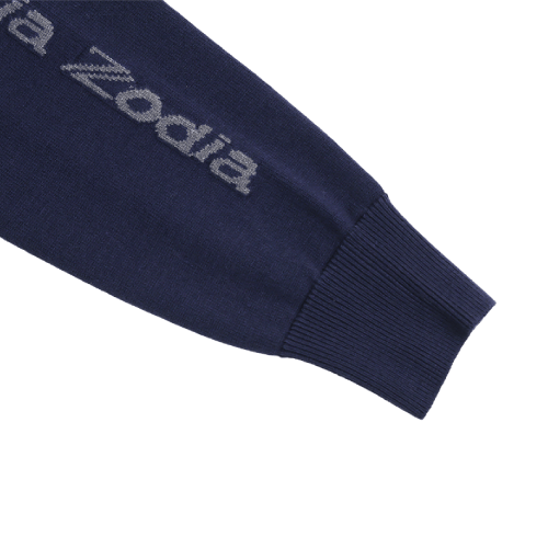 Close-up of the Zodia crewneck sweater sleeve showcasing logo detail and ribbed cuff design.