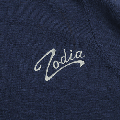 Zodia logo embroidered on a navy crewneck sweater fabric, showcasing stylish design and quality craftsmanship.