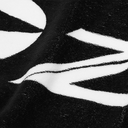 Close-up of Zodia Golf Towel featuring a black and white design, highlighting its soft cotton texture and plush feel.