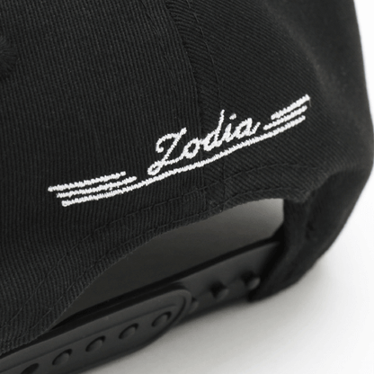 Black cap detail showing 'Zodia' embroidered logo on the back, emphasizing stylish design and adjustable fit.