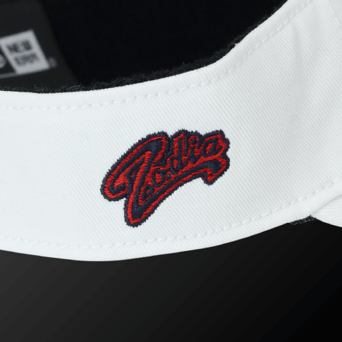 Close-up of Zodia x NEW ERA sun visor showing the embroidered logo on a white cotton band.