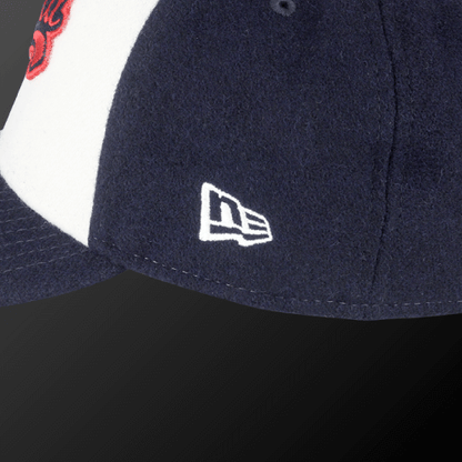Close-up of Zodia × NEW ERA wool cap showcasing navy blue color and iconic logo detail.
