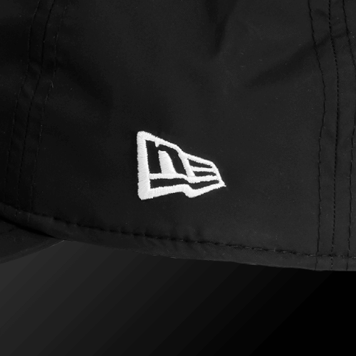 Close-up of Zodia Waterproof Rain Cap showing the logo on a black nylon material for high water resistance.