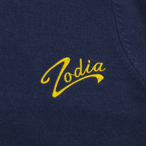 Zodia logo embroidered in yellow on a navy knit sweater, showcasing stylish and functional design.