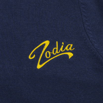 Zodia logo embroidered in yellow on a navy knit sweater, showcasing stylish and functional design.