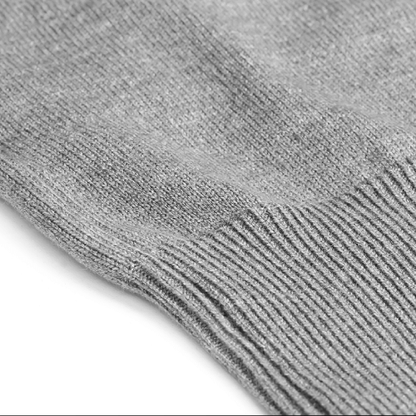Close-up of the Zodia Zip-Up Sweater's soft gray knit fabric, showcasing its timeless design and quality craftsmanship.